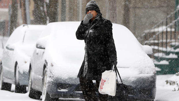 A pedestrian walks through morning snow Jan. 2, 2014, in Albany, N.Y. 