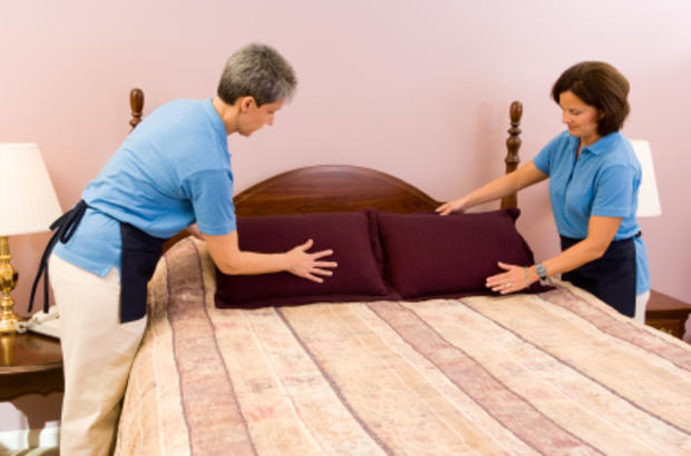 Maids Making a Hotel Room Bed 