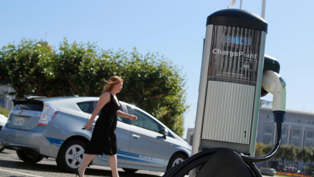 A pedestrian walks by a new electric vehicle charging station near San Francisco City Hall Aug. 25, 2010, in San Francisco, California. 