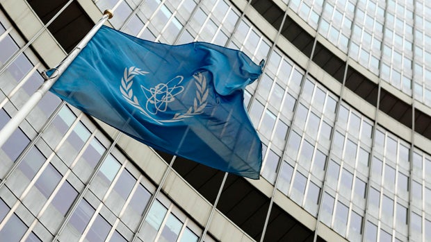 The flag of the International Atomic Energy Agency (IAEA) flies in front of its headquarters in Vienna Nov. 13, 2013. 