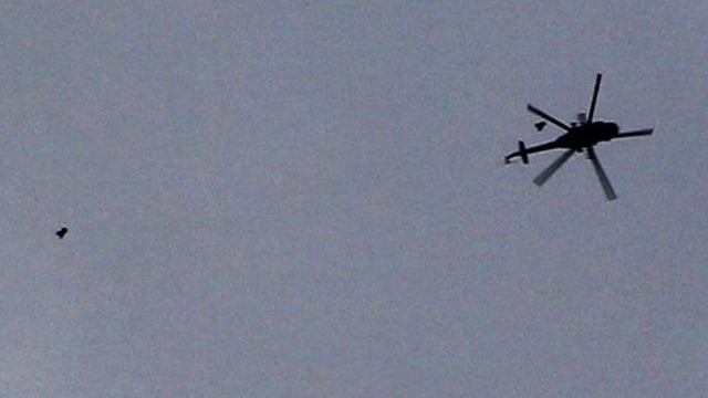A Syrian military helicopter drops what activists said were two barrel bombs in Aleppo 