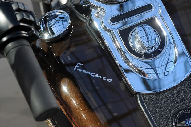 Pope Francis' signature is seen on the tank of a 2013 Harley-Davidson Dyna Super Glide Custom 