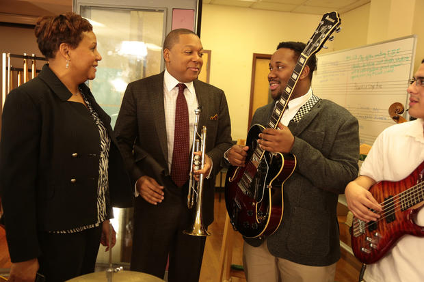 Wynton Marsalis discusses music theory with a student as Lynn Irby Jackson, principal of Newark's  Arts High School listens in. 