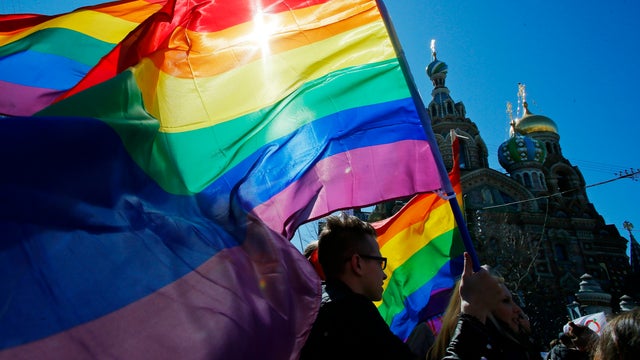 Gay rights activists carry rainbow flags as they march during a May Day rally in St. Petersburg, Russia 