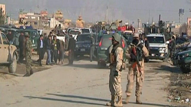 Afghan security forces are seen at the location of a bomb attack apparently targeting NATO forces in eastern Kabul 
