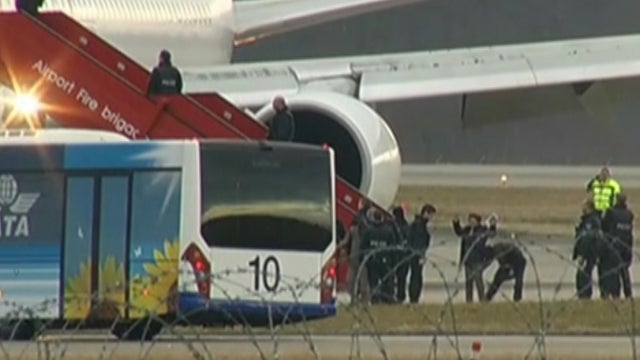 A passenger is screened after exiting an Ethiopian Airlines plane, which was allegedly highjacked by the co-pilot, on the tarmac at Geneva International Airport 