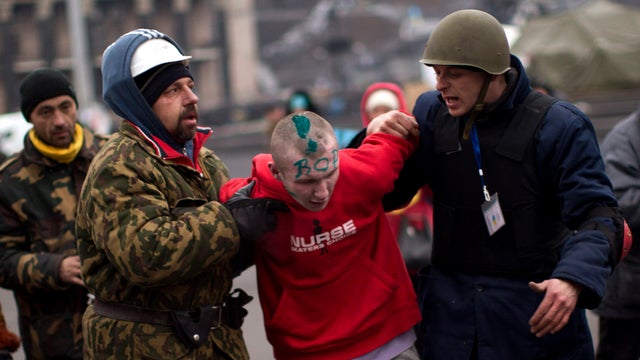 Anti-Yanukovich protesters detain a suspected thief in Kiev's Independence Square 
