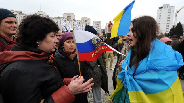 Pro-Russian (left) and pro-Ukrainian activists argue during a rally in Sevastopol 