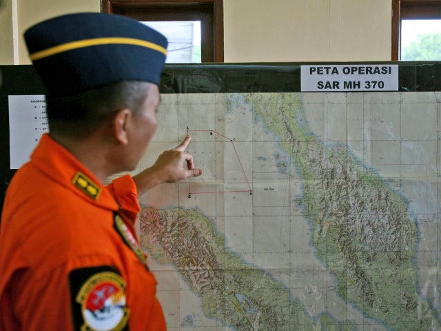 An Indonesia air force officer shows a map of Malacca Straits during a briefing prior to a search operation for the missing Malaysia Airlines Boeing 777 