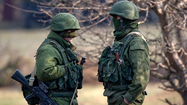 Pro-Russian soldiers stand outside the Ukrainian infantry base in Perevalne, Ukraine, March 12, 2014. 