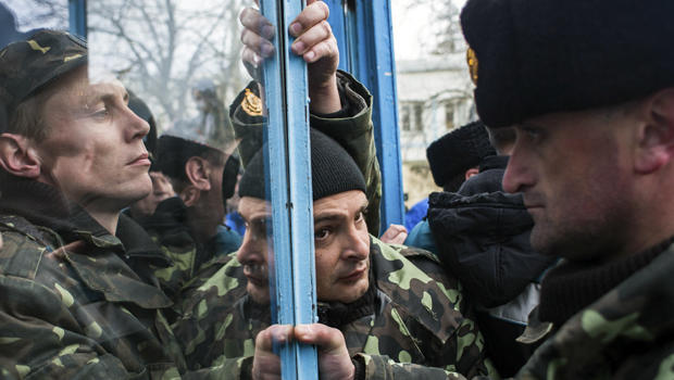 Ukrainian servicemen defend the entrance of the Ukrainian navy headquarters in Sevastopol, Crimea, March 19, 2014. 