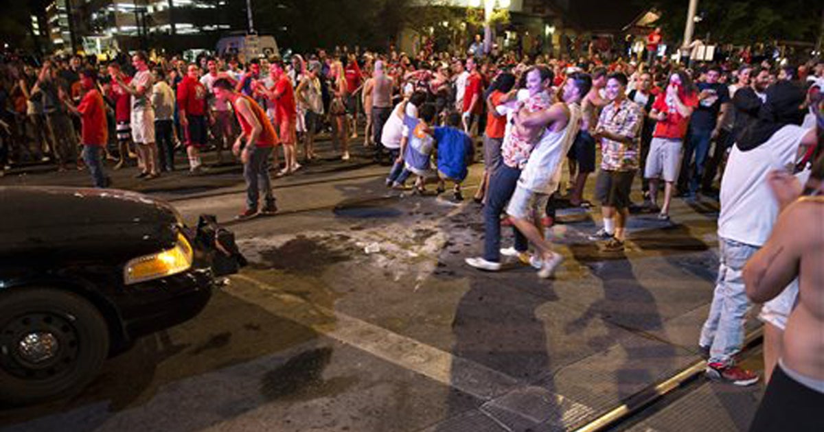 Police intervene after University of Arizona fans riot in the street ...
