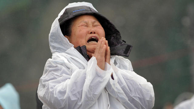 A relative weeps as she waits for missing passengers of a sunken ferry at Jindo port April 18, 2014, in Jindo-gun, South Korea. 