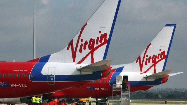 People board a Virgin Australia plane, Aug. 12, 2011, in Melbourne 