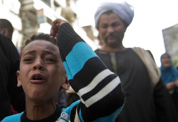 An Egyptian boy reacts outside the courtroom in Egypt's southern province of Minya after an Egyptian court sentenced Muslim Brotherhood leader Mohamed Badie and other alleged Islamists to death 