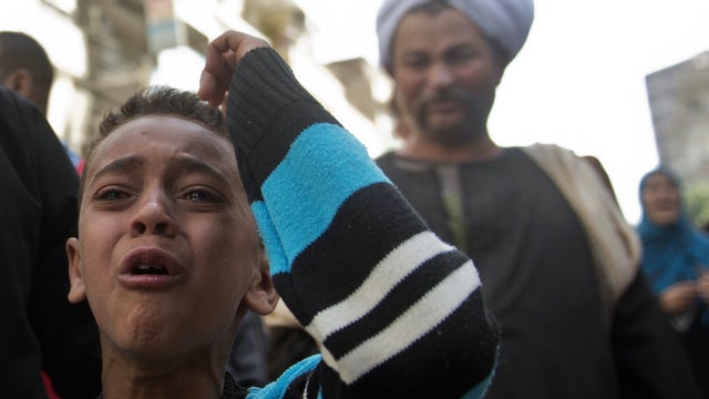 An Egyptian boy reacts outside the courtroom in Egypt's southern province of Minya after an Egyptian court sentenced Muslim Brotherhood leader Mohamed Badie and other alleged Islamists to death 
