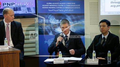 Gary Cunningham, center, of the Scotland Police, addresses the media during a news conference in Manila 