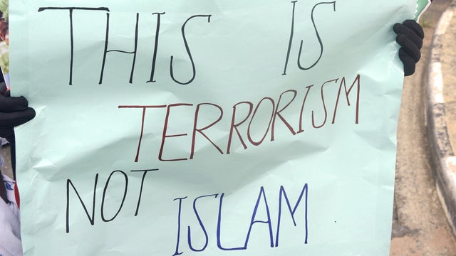 A woman holds a protest sign against the Islamic extremist group Boko Haram as Lagos-based civil society groups hold a rally at the state government house in Lagos 