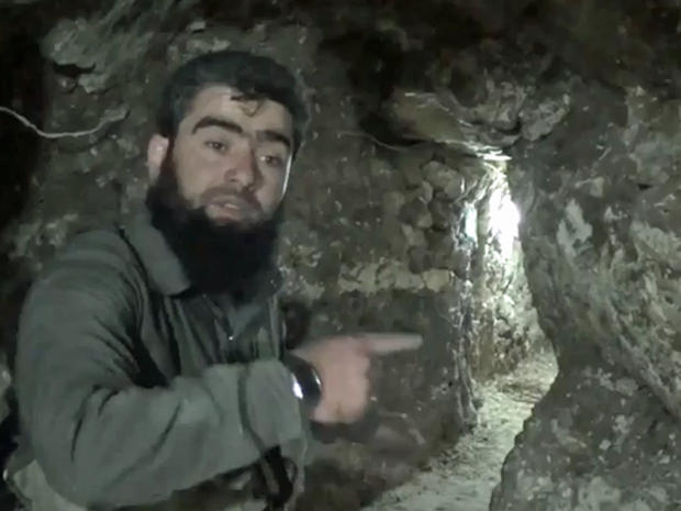 An image taken from video posted online in February, 2014 by the Syrian rebel group Islamic Front shows a militant in a tunnel allegeldy dug by the group underneath the Carlton Hotel in Aleppo 
