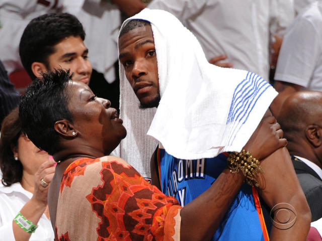 Texas basketball player Kevin Durant, left, walks with his mother, Wanda  Pratt, center and Texas coach