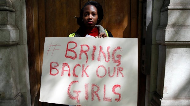 A protester holds a sign as she demonstrates against the kidnapping of schoolgirls in Nigeria, outside the Nigerian Embassy in London May 9, 2014. 