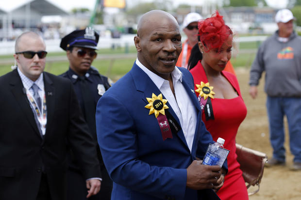 Former boxer Mike Tyson leaves the infield before the 139th Preakness Stakes at Pimlico Race Course in Baltimore May 17, 2014. 