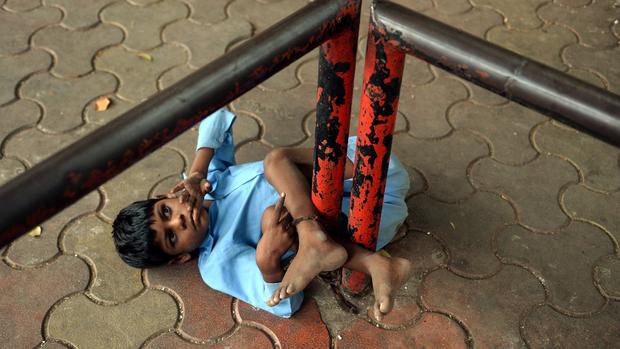 Disabled Indian boy tethered to bus stop as grandmother works 