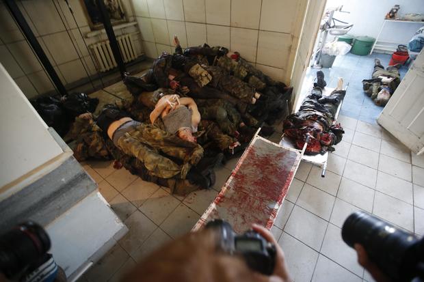 Bodies of separatists killed in a fight with pro-Ukrainian forces lay piled at a morgue in Donetsk 