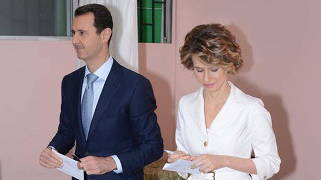 Syrian President Bashar Assad and his wife Asma cast their votes in the country's presidential elections at a polling station in Damascus 