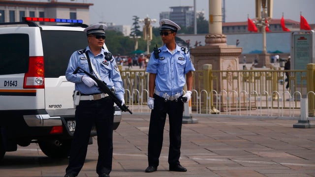 Armed police stand guard at Tiananmen Square in Beijing 