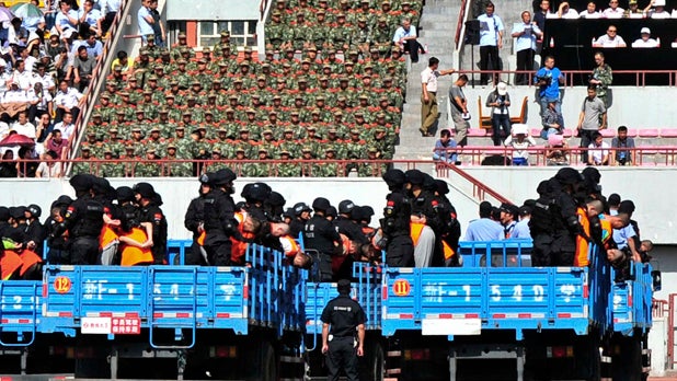 Trucks carrying criminals and suspects are seen during a mass sentencing rally at a stadium in Yili, Xinjiang Uighur Autonomous Region 