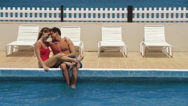 Couple On Cruise Ship water pool chairs 