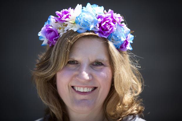Alisa Glenn poses for a portrait with her colorful hat before the 146th running of the 2014 Belmont Stakes in Elmont, New York, June 7, 2014. 