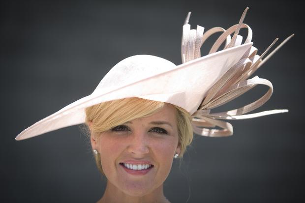 Carolyn Manno poses for a portrait with her hat before the 146th running of the 2014 Belmont Stakes in Elmont, New York, June 7, 2014. 