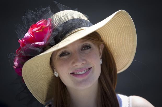Molly Andrews poses for a portrait with her colorful hat before the 146th running of the 2014 Belmont Stakes in Elmont, New York, June 7, 2014. 