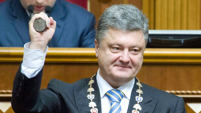 New Ukraine President Petro Poroshenko shows the presidential seal during his inauguration ceremony in parliament in Kiev June 7, 2014. 