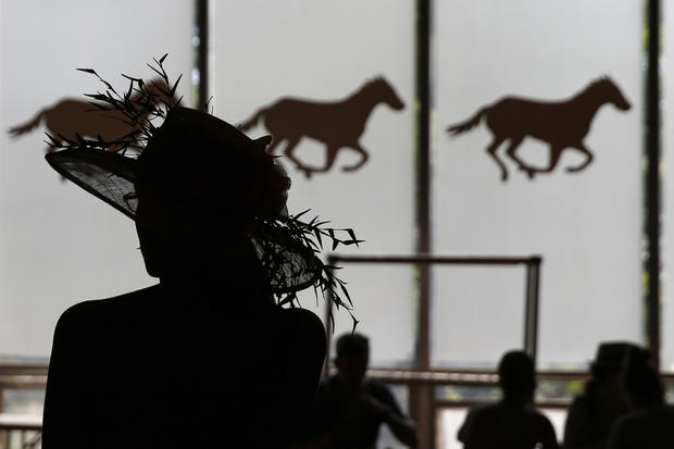 A woman is seen in silhouette at Belmont Park before the 2014 Belmont Stakes in Elmont, New York, June 7, 2014. 