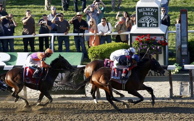 Tonalist, with jockey Joel Rosario in the irons (11), edges Commissioner, with jockey Javier Castellano in the irons (8), as Medal Count, with jockey Robby Albarado in the irons, follows at the 146th running of the Belmont Stakes at Belmont Park in Elmont 
