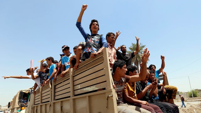 Volunteers who have joined the Iraqi army to fight against the predominantly Sunni militants who have taken over Mosul and other northern provinces travel in army trucks in Baghdad June 14, 2014. 