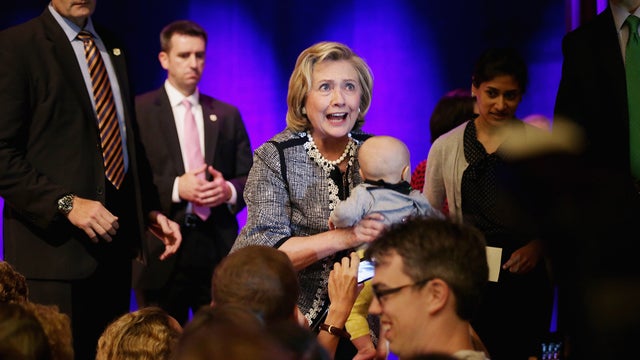 Former Secretary of State Hillary Clinton holds a baby at an event promoting her new book, "Hard Choices: A Memoir," on the campus of George Washington University June 13, 2014, in Washington, D.C. 