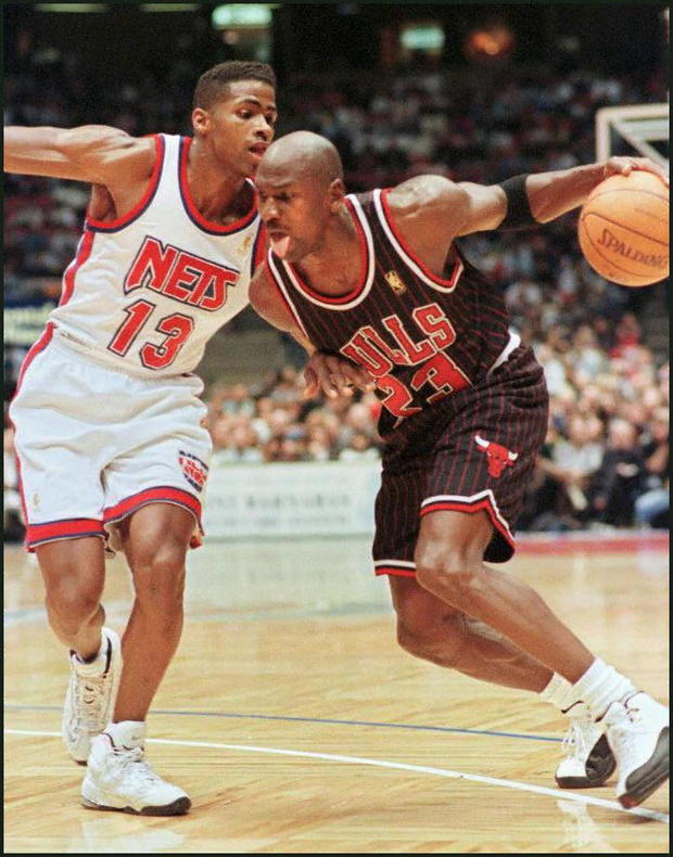 Michael Jordan (R) of the Chicago Bulls drives tow 