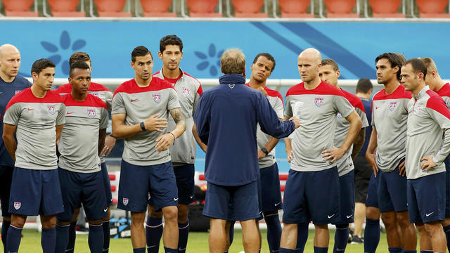 USA national soccer team head coach Jurgen Klinsmann, center, speaks to his players ahead of their training session in Manaus, Brazil, June 21, 2014. Portugal will play the USA June 22. 