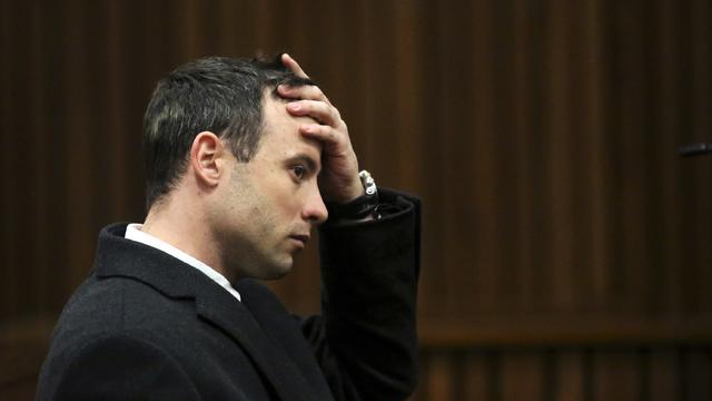 Oscar Pistorius gestures during his trial for the murder of his girlfriend Reeva Steenkamp 