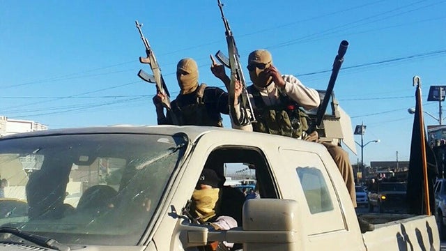 Militants from the Islamic State of Iraq and Syria celebrate the group's declaration of an "Islamic State," in Fallujah 