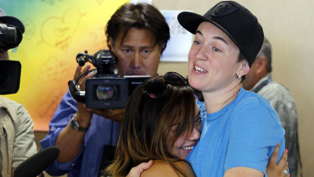 Samantha Getman, right, and Victoria Quintana embrace as they receive their marriage license at the Denver Clerk's office July 10, 2014. They were the first couple to be married in Denver, after clerk Debra Johnson began issuing licenses to same sex coupl 