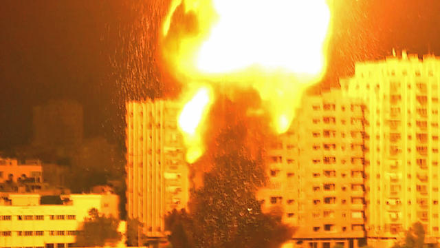 ​An Israeli rocket slams into a residential building in Gaza City 