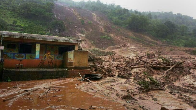 A mudslide surrounds a building in Malin village in Pune district the western Indian state of Maharashtra 