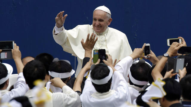 Pope Francis greets faithful as he arrives for the Holy Mass at Daejeon World Cup stadium 