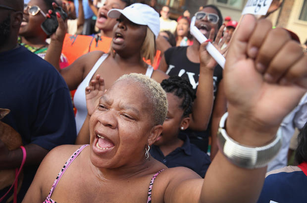 Roxann Evans joins other demonstrators protesting in the street where teenager Michael Brown was killed Aug. 14, 2014, in Ferguson, Missouri. 