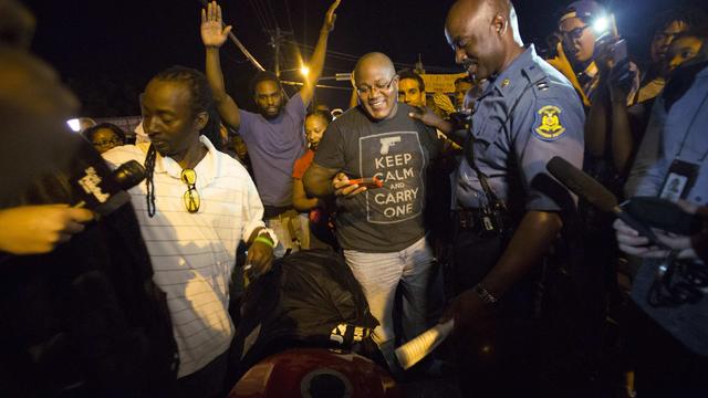 Highway Patrol Captain Ron Johnson talks to people during a peaceful demonstration, as communities react to the shooting of Michael Brown 